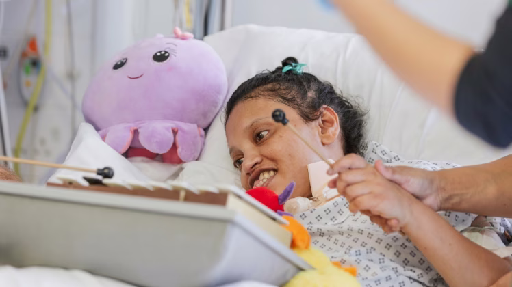 a patient plays a musical instrument on an ICU ward.