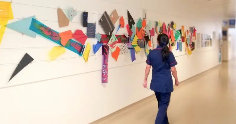a senior nurse looks at an art installation
