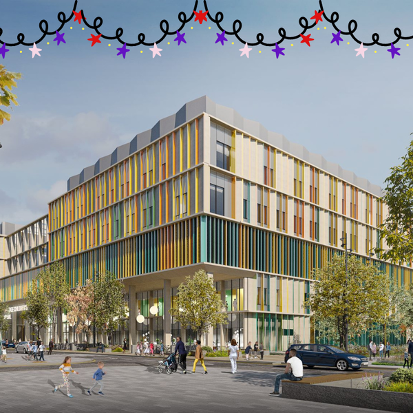 The front entrance of the future Cambridge Children's Hospital, with orange, yellow and blue facade and star fairy lights at the top of the image