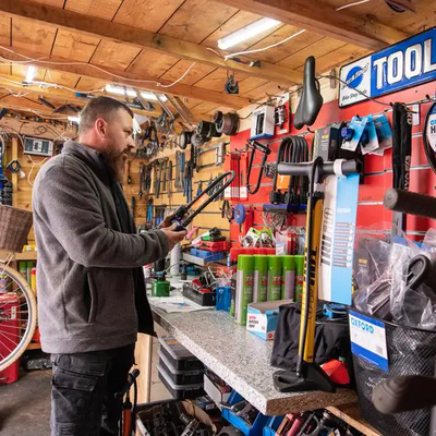 campus cycle hub colleague checks equipment within cycle hub building