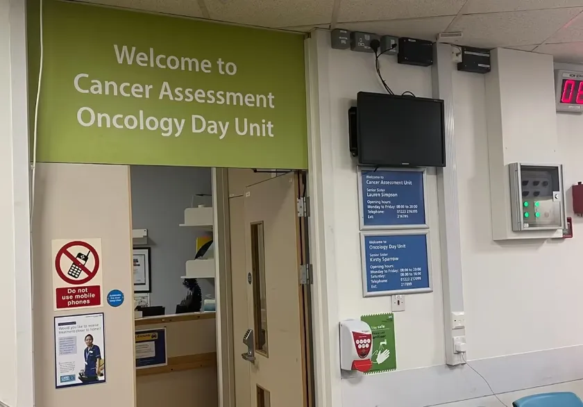 Entrance to the Cancer Assessment Unit. A sign 'Welcome to Cancer Assessment Oncology Day Unit is shown above the door.