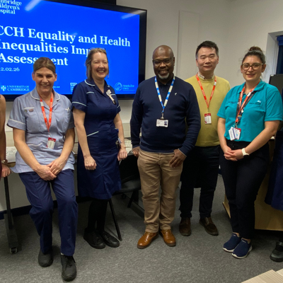 A group of people, including some nurses, standing in a room