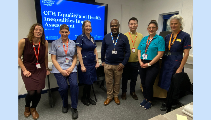A group of people, including some nurses, standing in a room