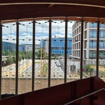 A view from inside the station across the campus showing the drop-off bay in the foreground with Addenbrooke's, Papworth and AstraZeneca behind.