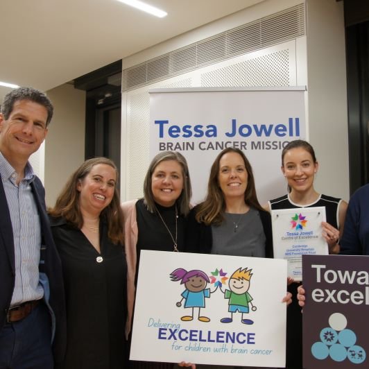 A group of clinical staff holding certificates of excellence