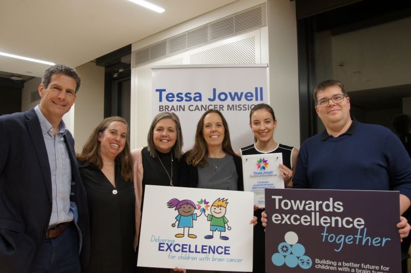 A group of clinical staff holding certificates of excellence