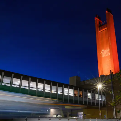Addenbrooke's chimney lit up orange for Stand Up To Cancer