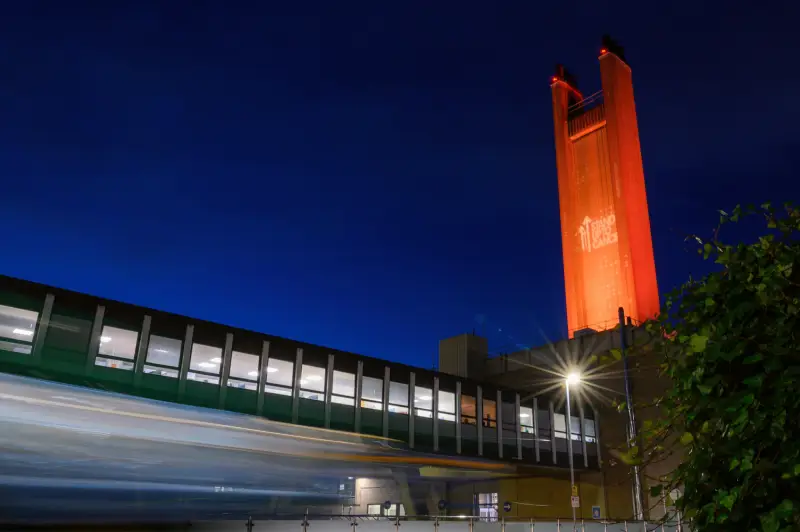 Addenbrooke's chimney lit up orange for Stand Up To Cancer