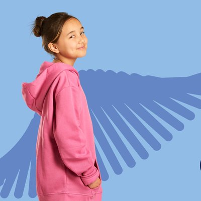 a child wearing a pink hoodie standing next to a 'genome'