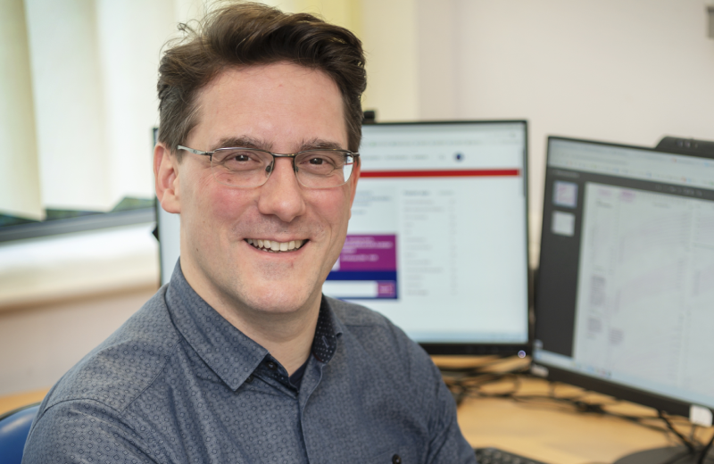 Dr Emile Hendriks sitting in front of a computer in a clinical consultation room