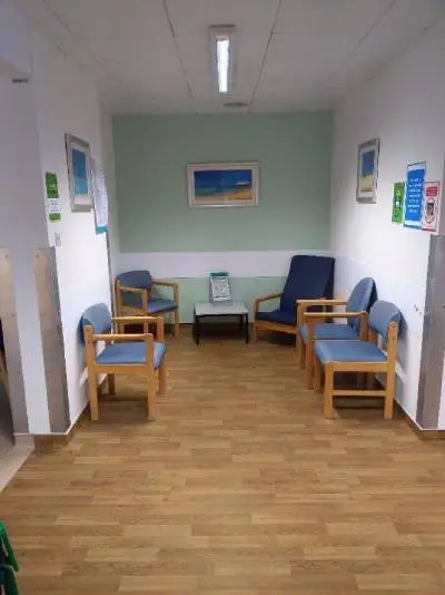 Fluoroscopy waiting area: five chairs and a small table with pictures on the walls