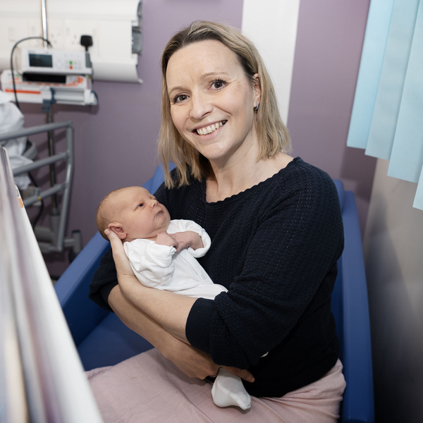 Frances holding a new born baby