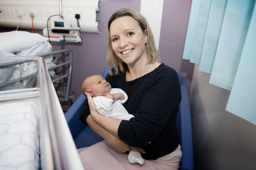 Frances holding a new born baby