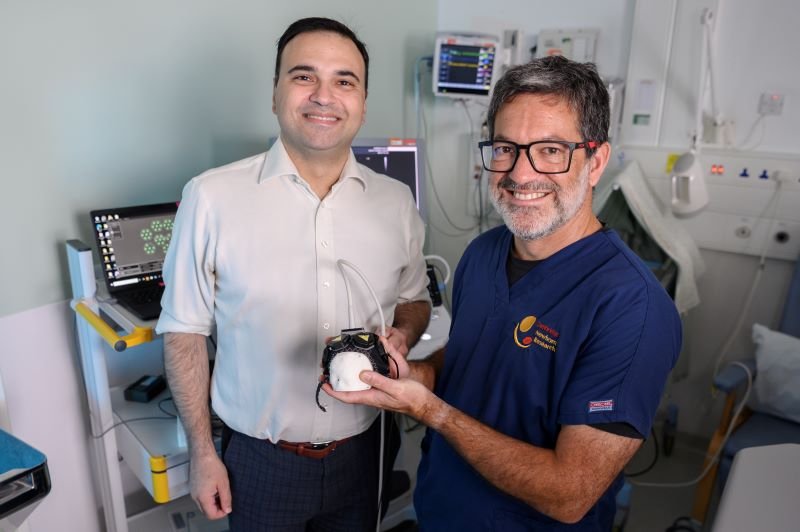 Two clinicians discussing a baby brain imaging cap (From left) Dr Alexis Joannides and Professor Topun Austin 800 x 532