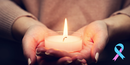 Pair of hands holding a candle