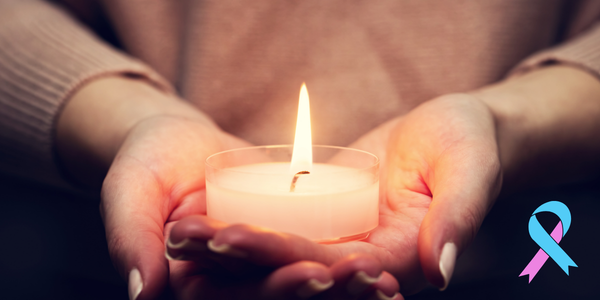 Pair of hands holding a candle