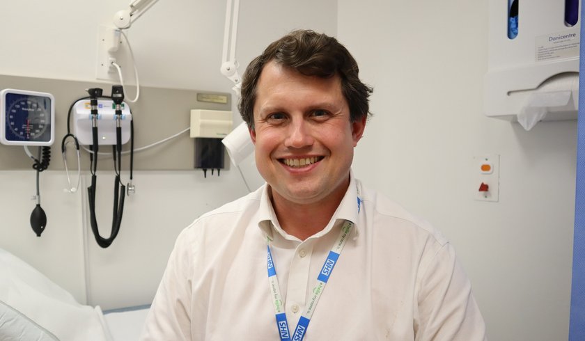 A photo of a man in a clinic with medical equipment