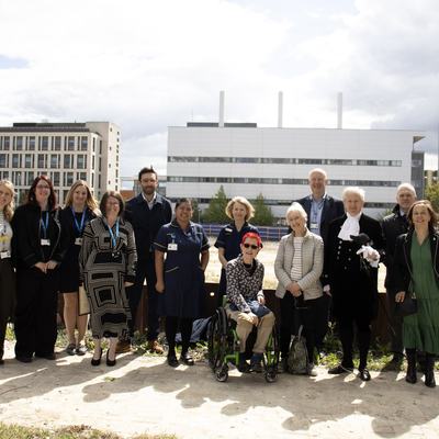 A group of people overlooking a hospital and a building site