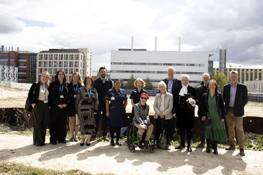 A group of people overlooking a hospital and a building site