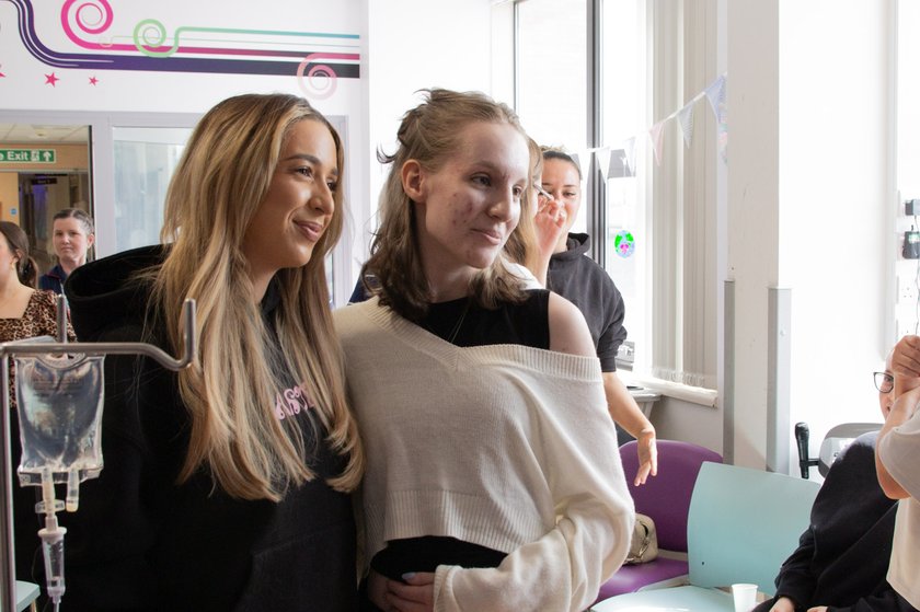 GK Barry posing for a photo with a young patient on the TCT unit