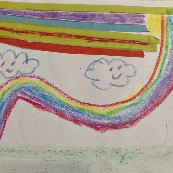 A child's crayon drawing of a rainbow with clouds