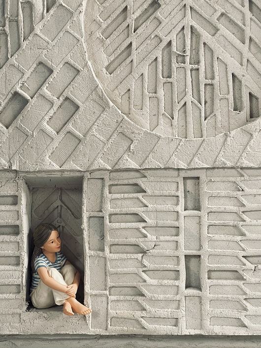 A model of an art sculpture, with a child sitting within it
