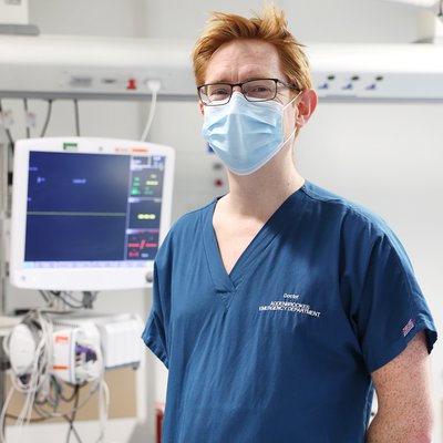 John is in the emergency department wearing a surgical mask