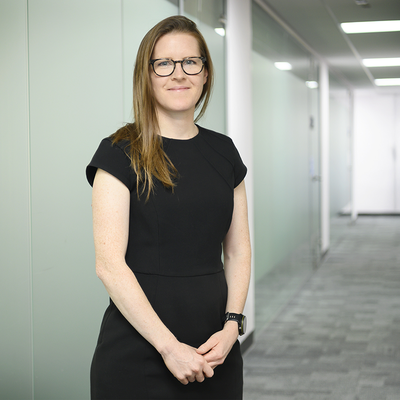 Kat Hymers standing in a corridor with a black dress on
