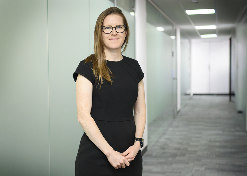 Kat Hymers standing in a corridor with a black dress on
