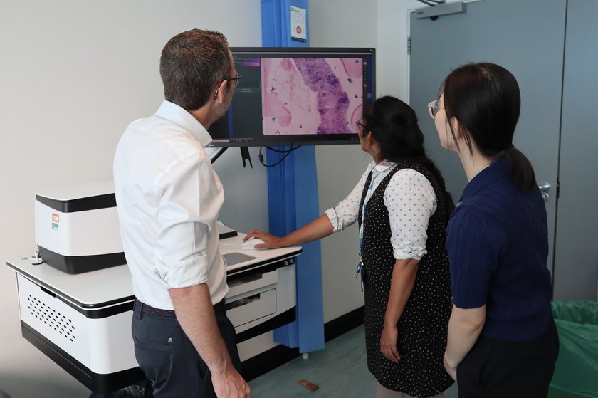 The Cambridge kidney One-Stop Mass Investigation Clinic team looking at images from the confocal microscope showing cancer tumours