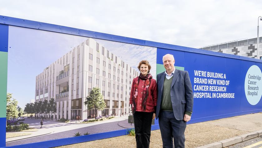 Dr Hugo Ford and Professor Rebecca Fitzgerald are pictured standing in front of the new CCRH site hoardings