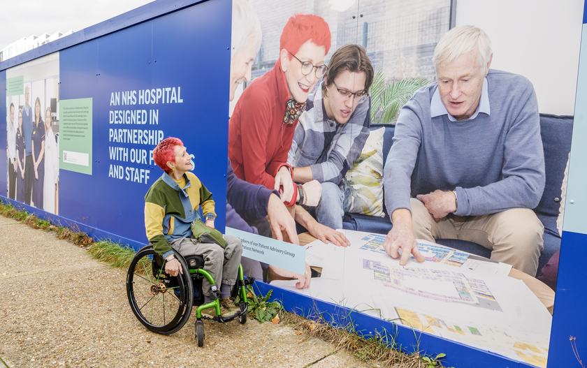 Fiona Care, Co-Chair of the Cambridge Cancer Research Hospital Patient Advisory Group, looks at her image on the new CCRH site hoardings