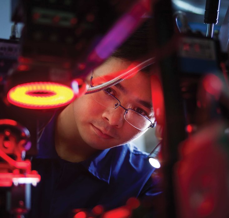 Man looking through research equipment