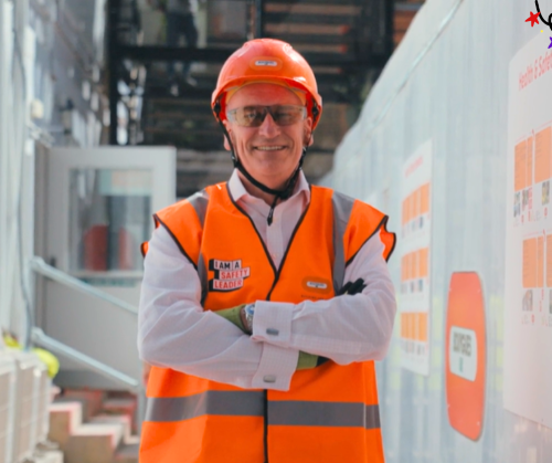A man wearing an orange hat and an orange high vis