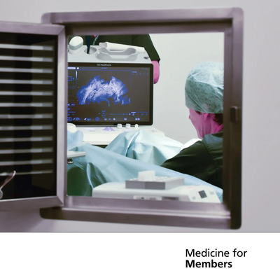 Open vent, showing through to doctor performing an ultrasound. The doctor can be seen facing the monitor, which is showing the scan.