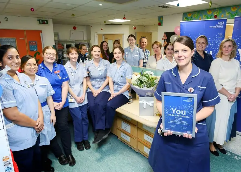 Niki and her wider team with her You Made a Difference award