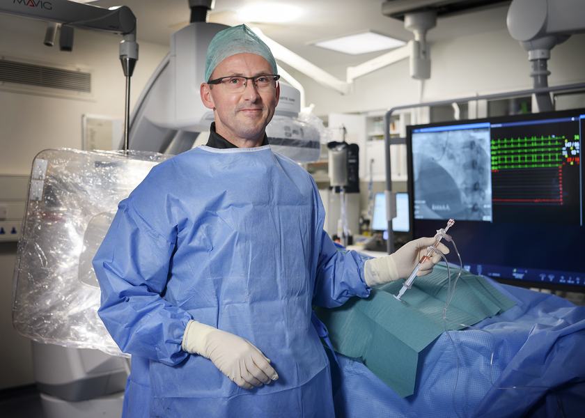 Peter Pugh in a theatres setting wearing scrubs