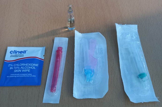 Equipment laid out: Clinell wipe 2ml syringe, Blue (or orange) needle, Red filter needle, Hydrocortisone ampule