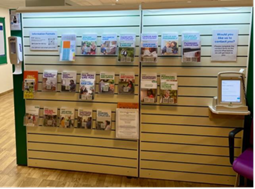 Information leaflets on a wall in the cancer support service information pod