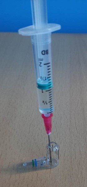 Syringe being loaded with hydrocortisone from ampoule