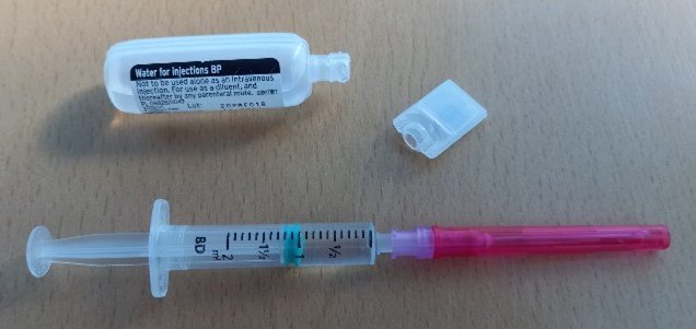 Water for injection alongside syringe