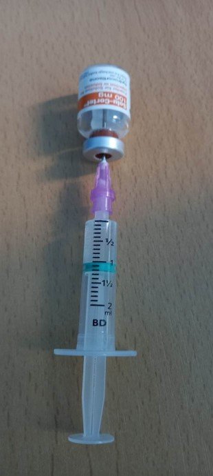 Syringe being loaded with Solu-Cortef from vial
