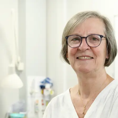 Pippa Corrie facing the camera in a clinical room