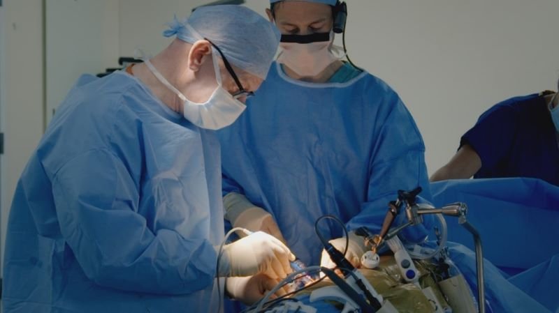 Professor Michael Nicholson (left) and Mr Jack Martin in operating theatre