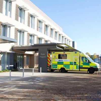 The entrance to the Rosie Hospital, with an ambulance outside