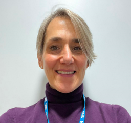 Juliette Howard - she has short hair and wears a purple top