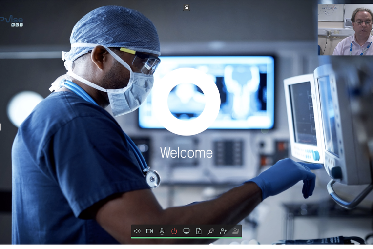Pulse MDT stock image of a surgeon looking at screens with a web camera image of a man in the top right and meeting control bar at the bottom