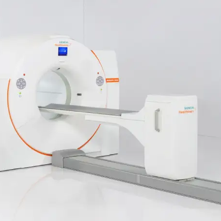 The new total-body PET scanner a large white ring-shaped machine that patients will lie within during scans