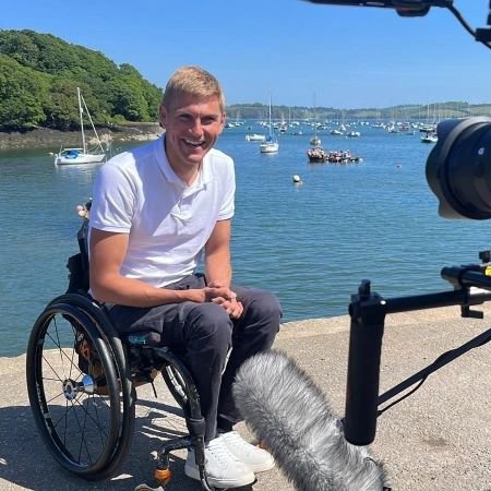 TV presenter and Paralympian Steve Brown in wheelchair near sea