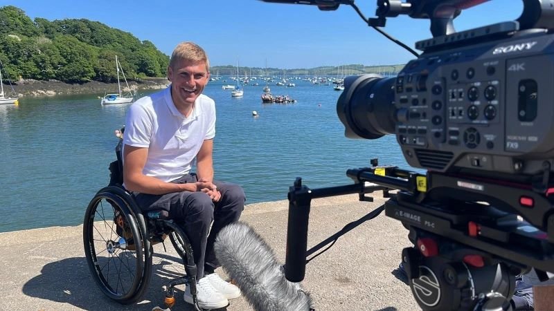 TV presenter and Paralympian Steve Brown in wheelchair near sea
